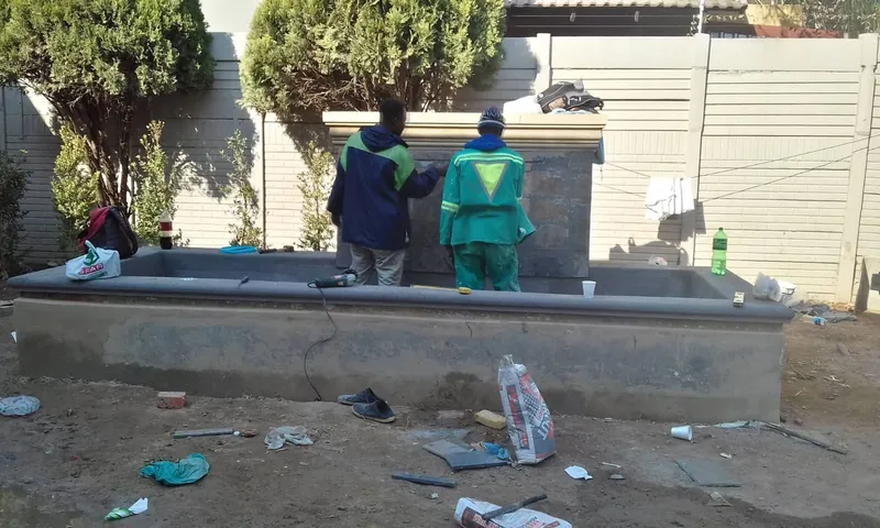 New pool under construction with workers building the structure